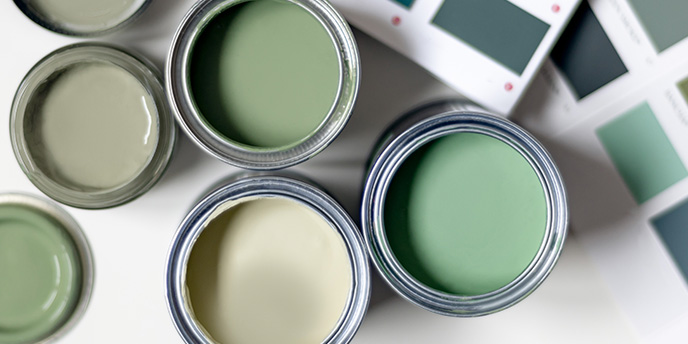 Open Cans of Green Paint in Different Shades and Green Paint Color Swatches