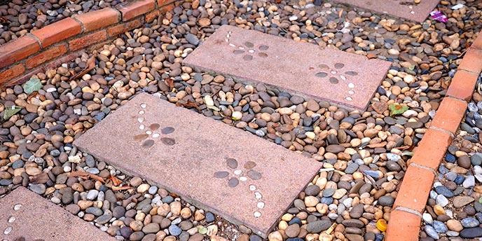 Decorative Paver Stones in a Gravel Walkway